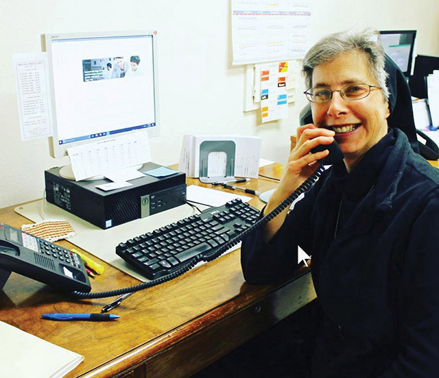 Sister Ruth Starman, O.S.B. takes a moment from her work for a smile.