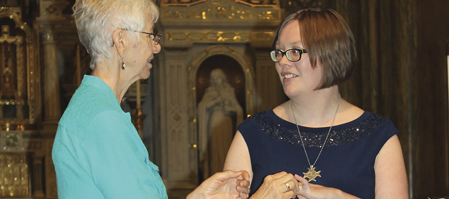 Sister Cecilia Corcoran, F.S.P.A. presents Sister Julia Walsh, F.S.P.A. with a ring during her final vows ceremony.