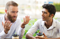 Two men talking over coffee