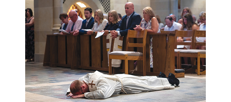 When a man is ordained, he lies prostrate on the floor as a symbol of giving over his entire life to service, as shown here in the Diocese of Rochester, New York.